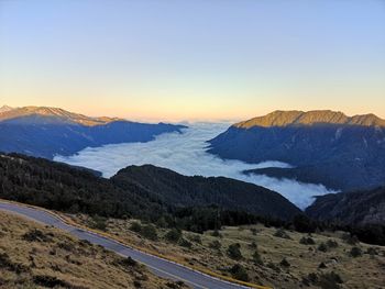 Scenic view of snowcapped mountains against clear sky during sunset