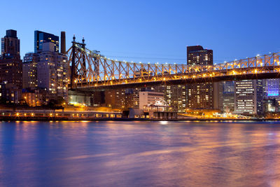 Illuminated cityscape against sky at night