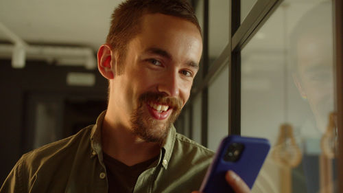 Portrait of young man using mobile phone