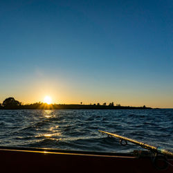 Scenic view of sea against clear sky during sunset