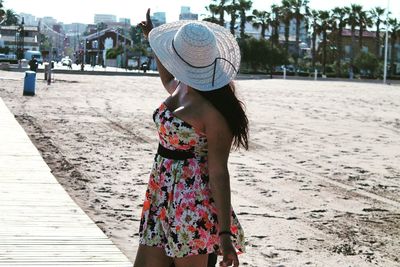 Woman in dress standing on sand