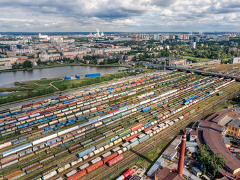 Aerial top view on railways with various colorful cargo wagons. import and export logistics. 