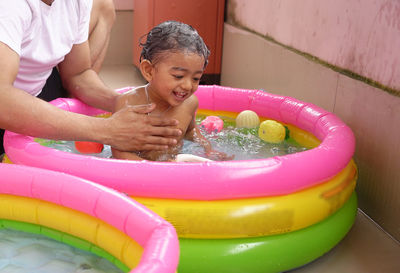 Full length of girl playing in water