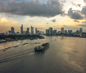 View of city at waterfront during sunset