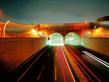 Light trails on road in illuminated tunnel