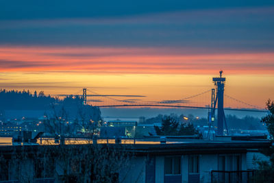 Illuminated bridge against sky at sunset
