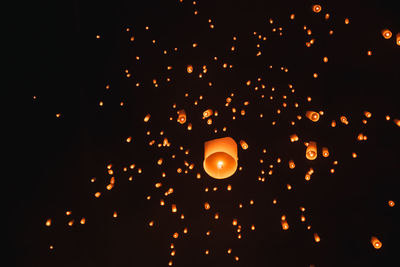 Low angle view of illuminated lantern against sky at night