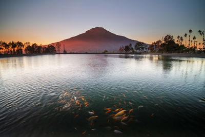 Scenic view of lake against sky during sunset