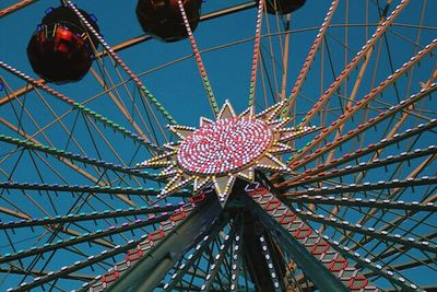 Low angle view of ferris wheel against sky