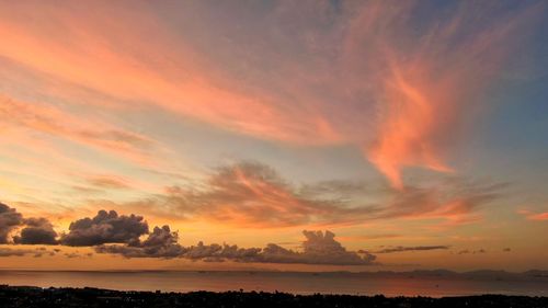 Scenic view of dramatic sky over sea during sunset