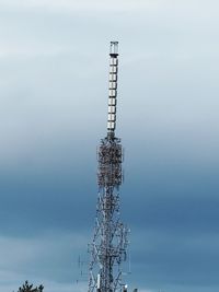 Low angle view of communications tower against sky