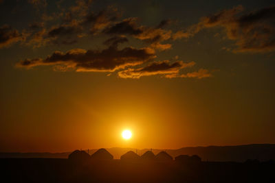 Scenic view of silhouette mountains against sky during sunset