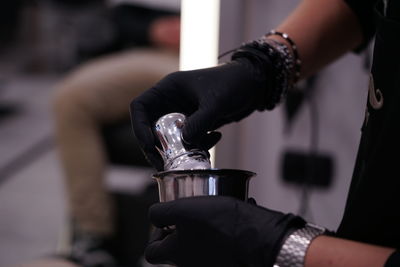 Close-up of person making coffee