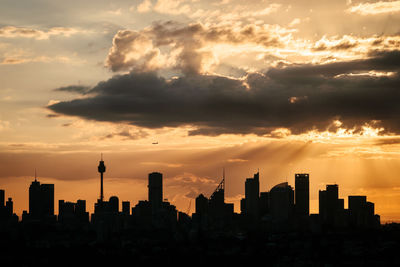 View of cityscape against cloudy sky during sunset