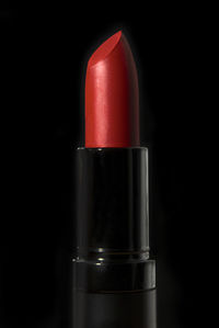 Close-up of red lipstick against black background