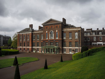 Facade of historic building against cloudy sky