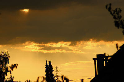 Low angle view of silhouette trees against sky during sunset