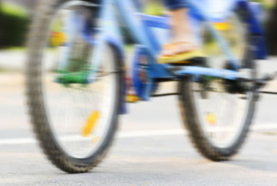 Blurred motion of bicycle on road
