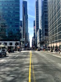 People walking on road along buildings