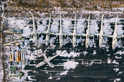 Aerial view of abandoned helicopters on land during winter