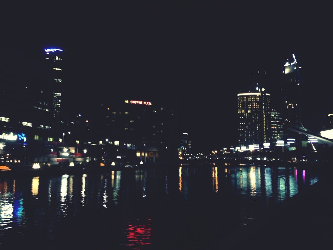 night, illuminated, architecture, built structure, water, building exterior, reflection, waterfront, city, river, skyscraper, sky, modern, building, clear sky, outdoors, no people, tower, tall - high, dark