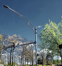 Low angle view of power lines against blue sky