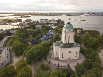 A church and a lighthouse in suomenlinna sea fortress in helsinki, finland.