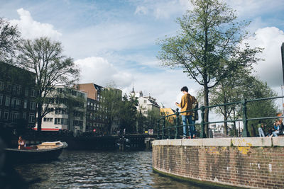 Man in city against sky