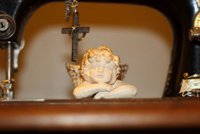 Close-up of cross on sewing machine at home