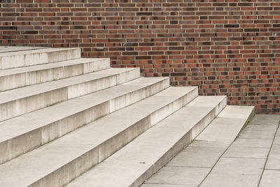 View of staircase against brick wall