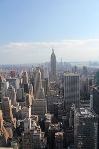 Aerial view of buildings in city against sky