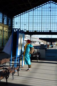 Side view of woman reading map at railroad station