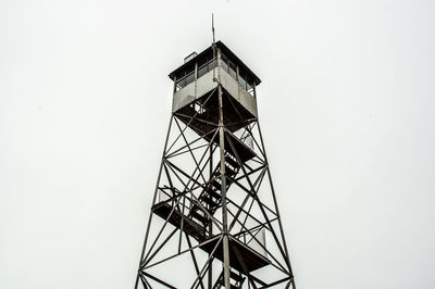 Low angle view of communications tower against sky