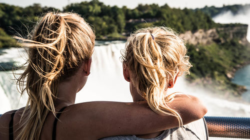 Rear view of women looking at waterfall