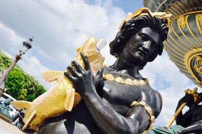 Low angle view of statue against cloudy sky