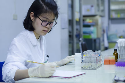 Scientist working at table in laboratory