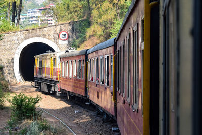 Kalka shimla toy train moving on mountain slopes, beautiful view, one side mountain, one side valley