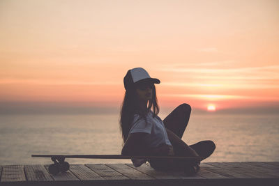 Beautiful young girl with her skateboard