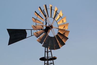 Low angle view of traditional windmill against clear sky