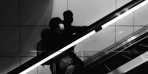 Low angle view of people standing on staircase