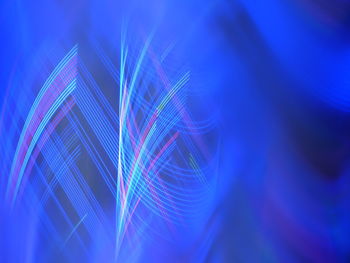 Full frame shot of light trails on blue background