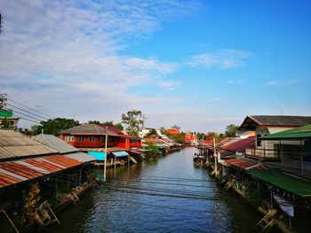 Boats moored in water against sky