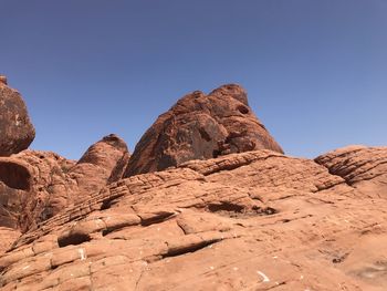 Rock formations against clear blue sky