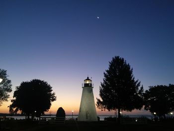 Silhouette of lighthouse at night