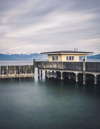 View of bridge over sea against buildings