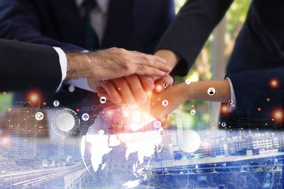 Midsection of business people shaking hands