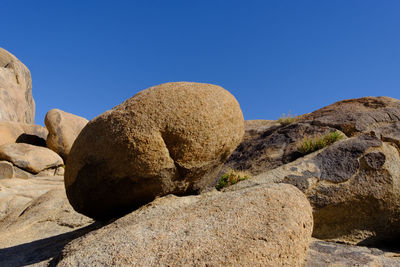 Rock formations against clear blue sky