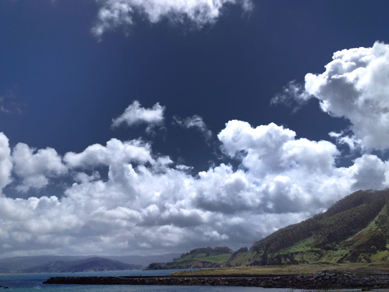 sky, tranquil scene, scenics, tranquility, beauty in nature, cloud - sky, water, nature, cloud, mountain, cloudy, sea, landscape, idyllic, waterfront, blue, day, mountain range, cloudscape, non-urban scene