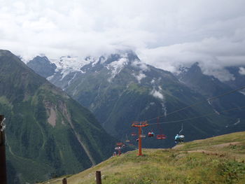 Scenic view of mountains against cloudy sky