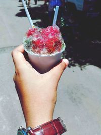 Close-up of hand holding ice cream